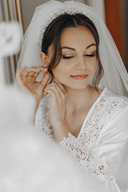 istock A bride is getting ready for her wedding and is putting on her veil 2207735095