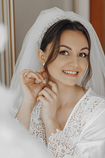 istock A bride is getting ready for her wedding and is putting on her veil 2207735096