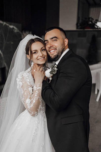 istock A bride and groom are posing for a picture 2207735173
