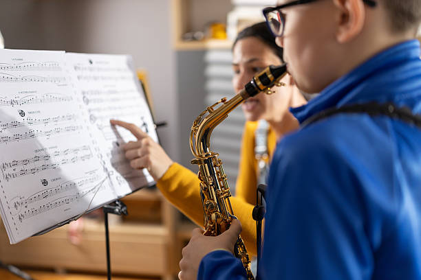 istock Saxophone play lesson with female teacher 2207736624