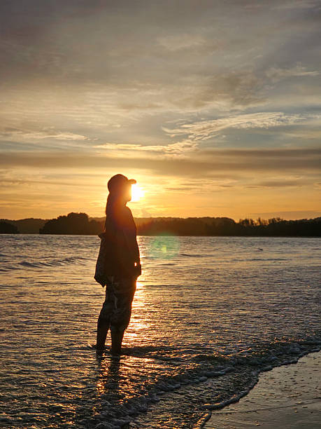 istock A woman sea and Sunset 2207738773
