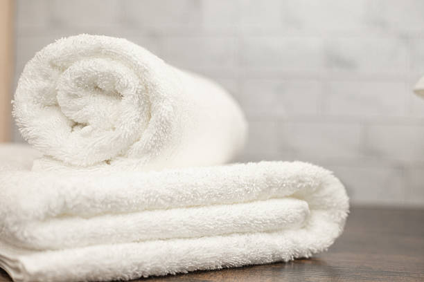 istock White terry towels. Folded white towel. Towel on the shelf 2207739933