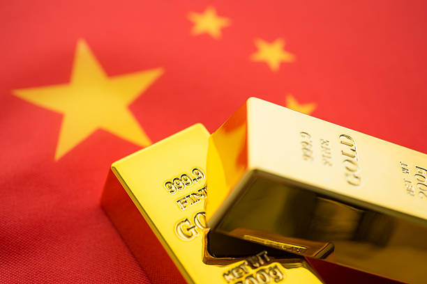 istock Two gold bars with Chinese flag background. 2207741001