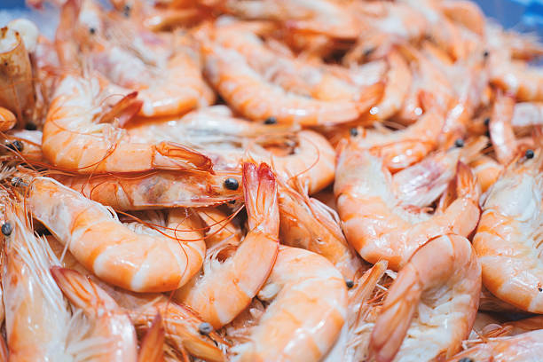 istock Freshly cooked shrimps piled on ice, displaying vibrant orange hues and delicate textures, create an enticing sight at the market, ready for seafood lovers seeking quality ingredients 2207741115