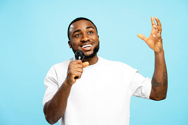 istock Handsome, attractive stylish singer holding microphone and singing with joy 2207741913