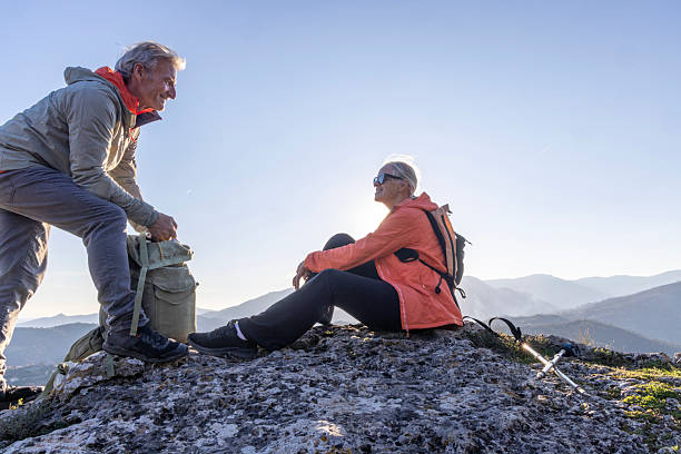 istock Mature couple relax on mountain top at sunset 2207743272