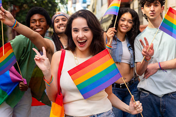 istock Young activists celebrating with rainbow flags at pride parade 2207743374
