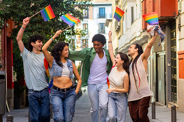 istock Young activists marching with rainbow flags for lgbtq plus rights 2207743391