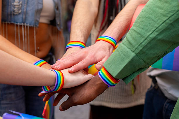 istock Activists showing support and solidarity at pride parade with rainbow bracelets 2207743411