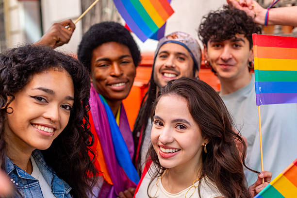 istock Young activists holding rainbow flags celebrating pride month 2207743438