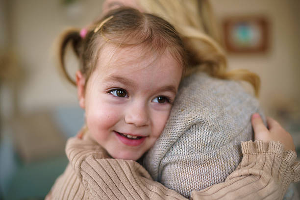 istock Happy little girl hugging her mother 2207744761