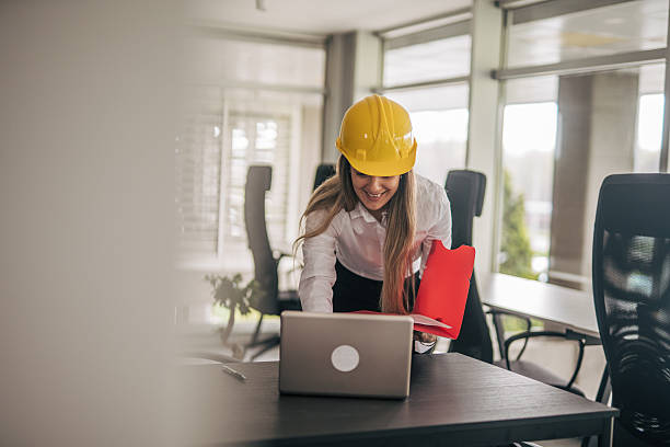 istock Female architect reviewing documents on laptop in office 2207745081