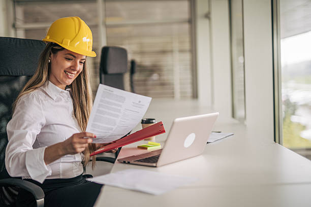 istock Female architect reviewing documents at her desk in the office 2207745230