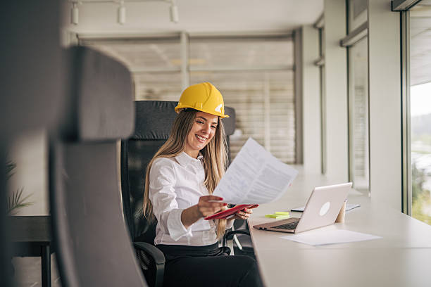 istock Female architect reviewing documents at her desk in the office 2207745341
