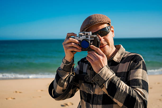 istock Enjoying the sunny Algarve beach while capturing moments with an vintage analog camera 2207745391