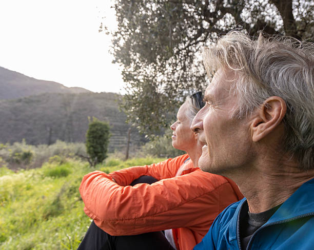istock Mature couple with bicycles sit under olive tree 2207746351