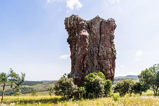 istock Tall Rock Formation in Green Landscape 2207746359