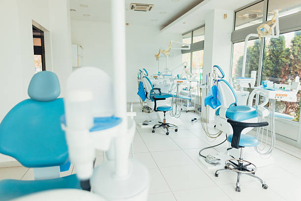Several modern dentist chairs and advanced equipment waiting for patients in a clean, bright dental office, highlighting a professional atmosphere for oral health and hygiene