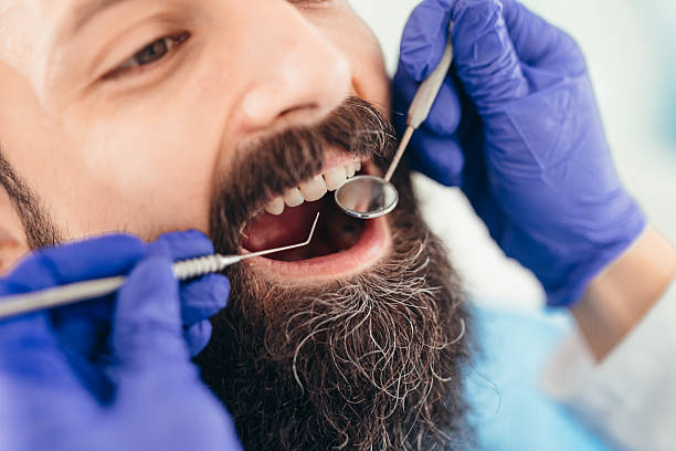 istock Dentist examining patient's teeth with dental tools in clinic 2207746723
