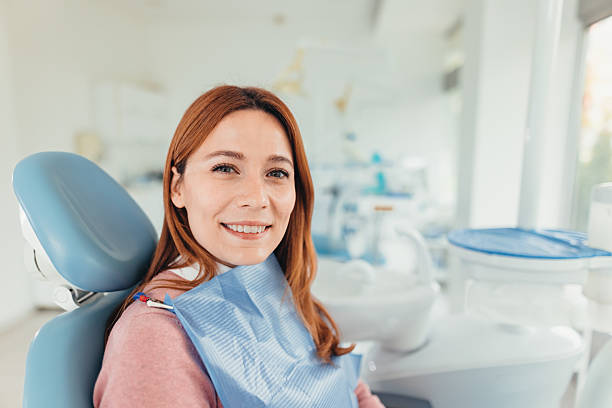 istock Patient smiling while sitting on dentist chair in dental office 2207746835