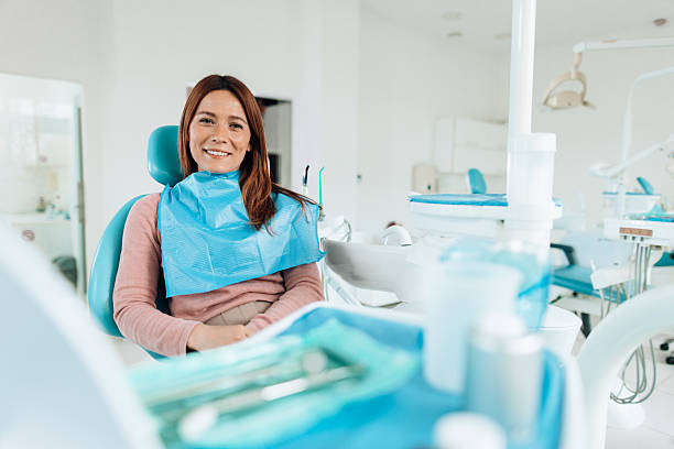 istock Patient smiling while sitting on dentist chair in dental office 2207747059