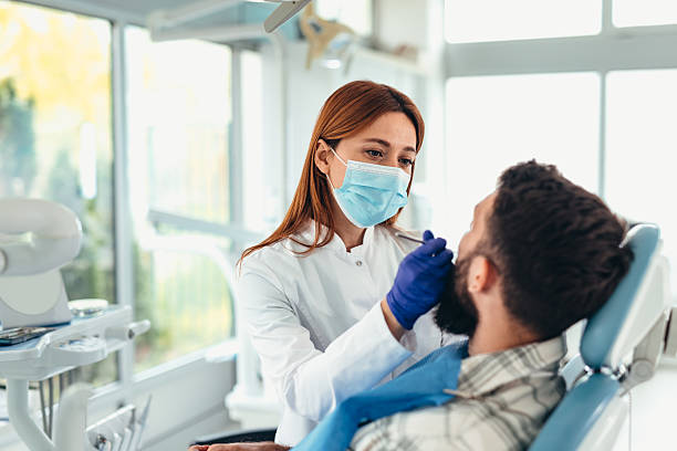 dentist examining patient's teeth in dental office - förebyggande sjukvård bildbanksfoton och bilder