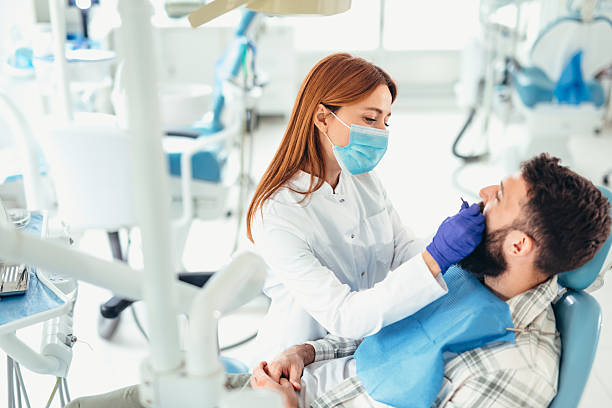 istock Dentist examining patient's teeth in dental office 2207747310