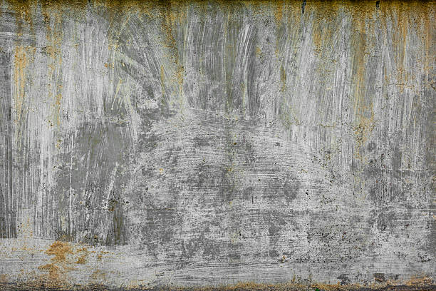 istock rough concrete wall with old white paint strokes yellow streaks and stains 2207747651