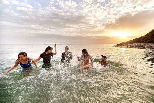 istock Splashing in the sea at sunset! 2207747825