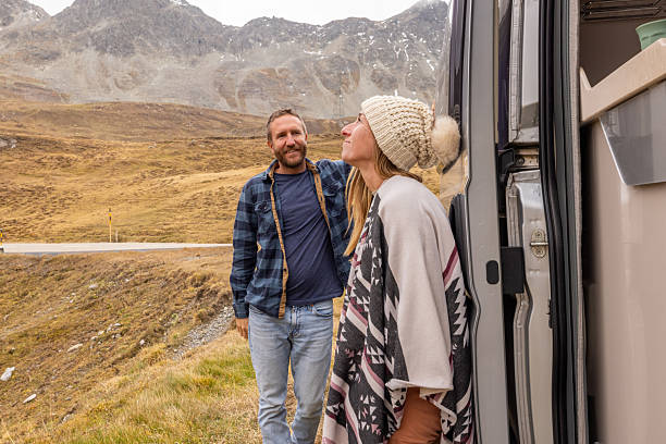 istock Couple Embracing Mountain Views on Road Trip 2207749310