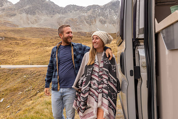 istock Couple Embracing Mountain Views on Road Trip 2207749312