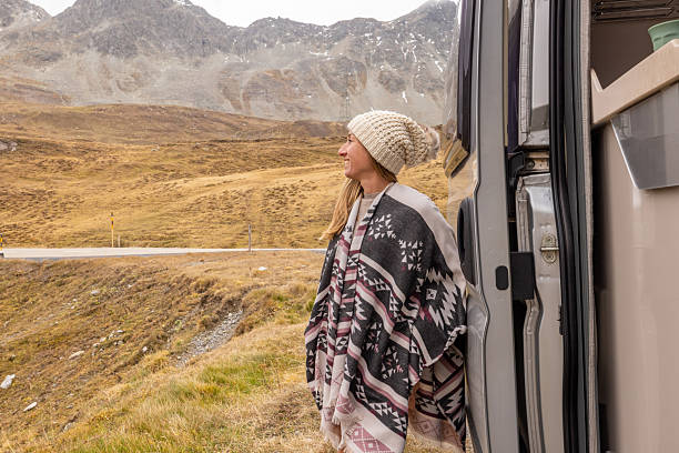 istock Woman Enjoying Mountain View from Camper Van 2207749316