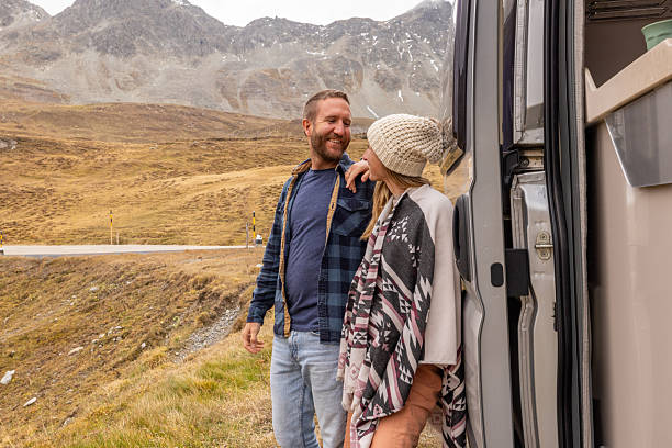 istock Couple Embracing Mountain Views on Road Trip 2207749322