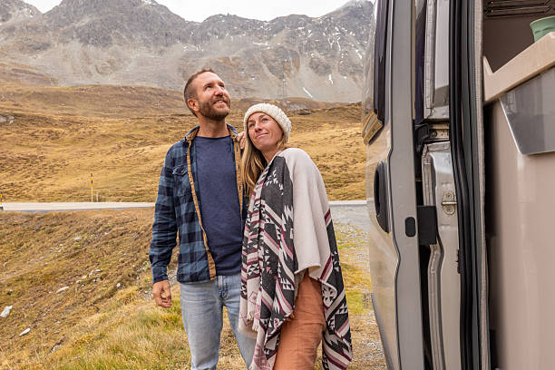 istock Happy Couple Embracing Mountain Views on Road Trip 2207749329