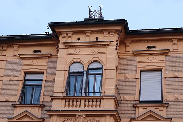 istock Facade fragment of a historic building with arched windows, decorative molding, and brickwork. 2207750662