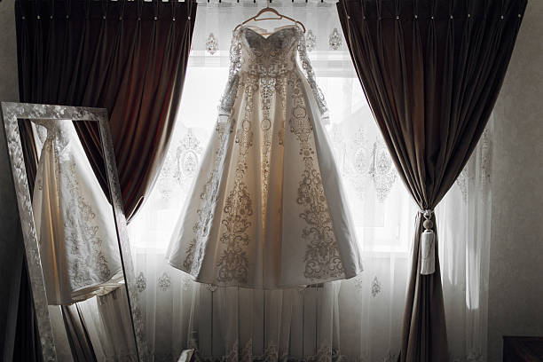 istock A white dress is hanging in front of a mirror 2207751952