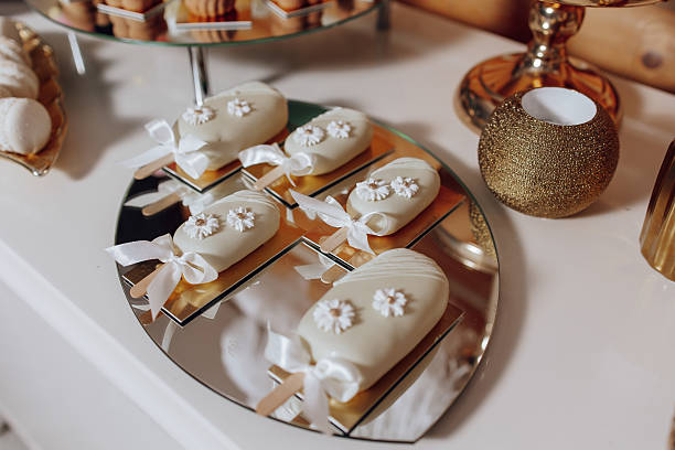 istock A table with a white plate of pastries with white bows on them 2207752197