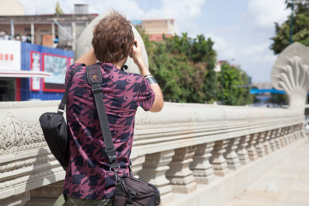Tourist captures memories while exploring the beautiful architecture in Cambodia