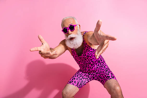 Photo of charismatic elderly cool man fingers point you dancing wear leopard print overall isolated on pink color background Photo of charismatic elderly cool man fingers point you dancing wear leopard print overall isolated on pink color background. gay man men sunglasses party stock pictures, royalty-free photos & images
