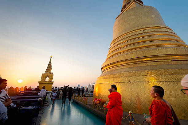 Bangkok,Thailand-January 21 2024: As the sun goes down,many people come to watch and take photos,by climbing up to this highest point,next to the golden stupa.