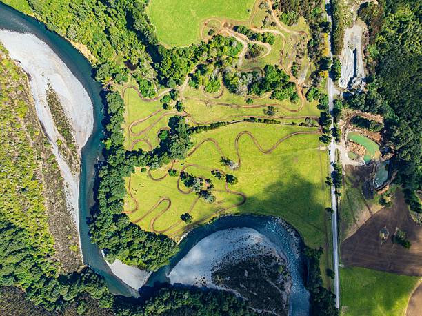 istock Aerial view of a winding river through lush green fields. 2207757247