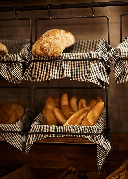 Twisted sweet baked bread buns in a wicker basket. Bakery shop counter