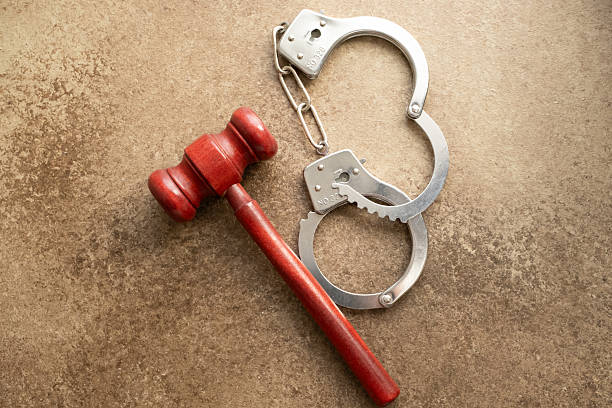 istock handcuffs and judge's hammer 2207759117