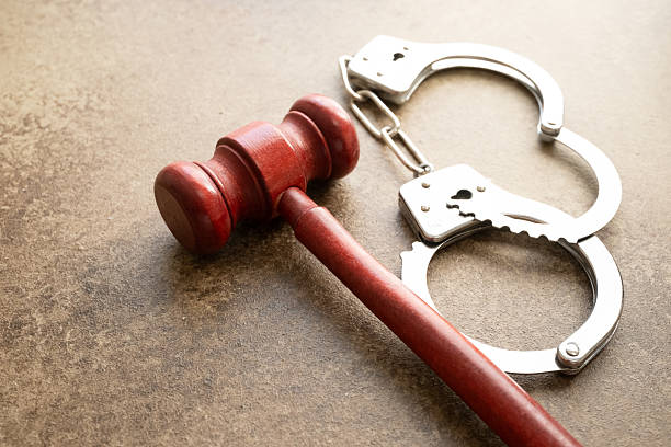 istock handcuffs and judge's hammer 2207759119