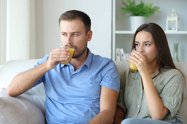 istock Couple drinking orange juice at home 2207761172