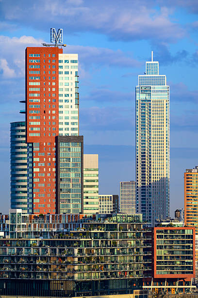 Rotterdam skyline with skyscrapers at the Kop van Zuid during a beautiful early morning. The Montevideo and Zalmhaven are standing tall amongst converted warehouses and office buildings.
