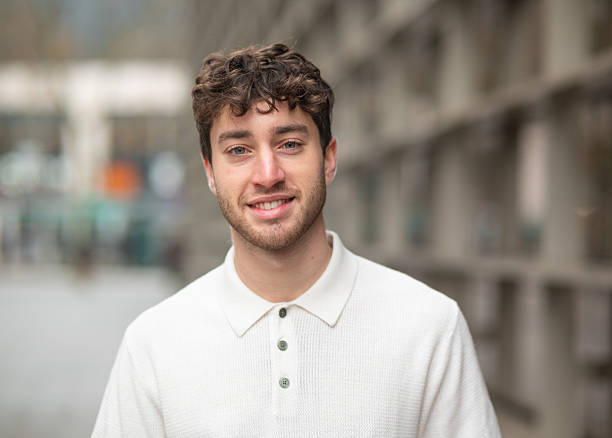 istock Young man smiling at the camera in urban setting 2207762728