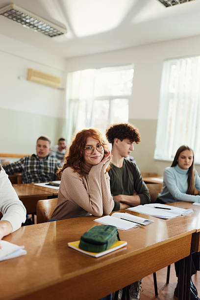 istock Smiling redhead student enjoying on a class at high school. 2207763522