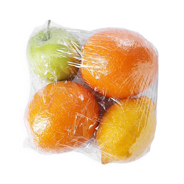 istock Fresh fruits with plastic food wrap isolated on white, top view 2207763672