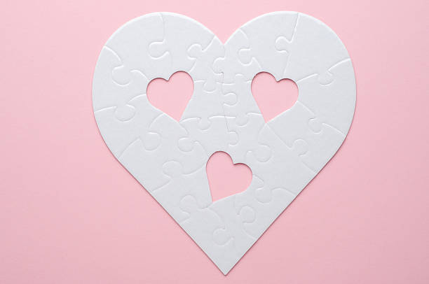 istock White heart-shaped jigsaw puzzle on a grey background, with several pieces missing and placed nearby. Symbolizing love, connection, or incompleteness, perfect for themes of relationships and emotions. 2207765441